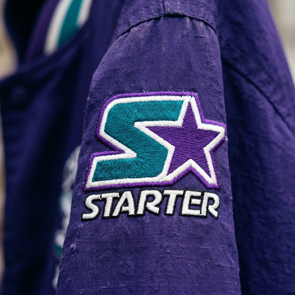 A detailed close up of the iconic embroidered Starter star logo on the sleeve left